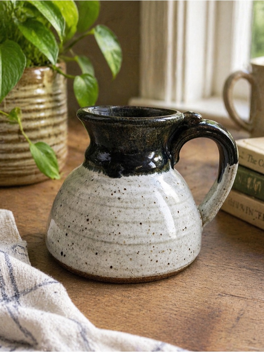 Speckled Ceramic Pitcher with Glossy Black Rim and Handle
